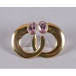 A pair of 18 carat 750/1000 gold ear studs with 2 oval faceted pink sapphires.