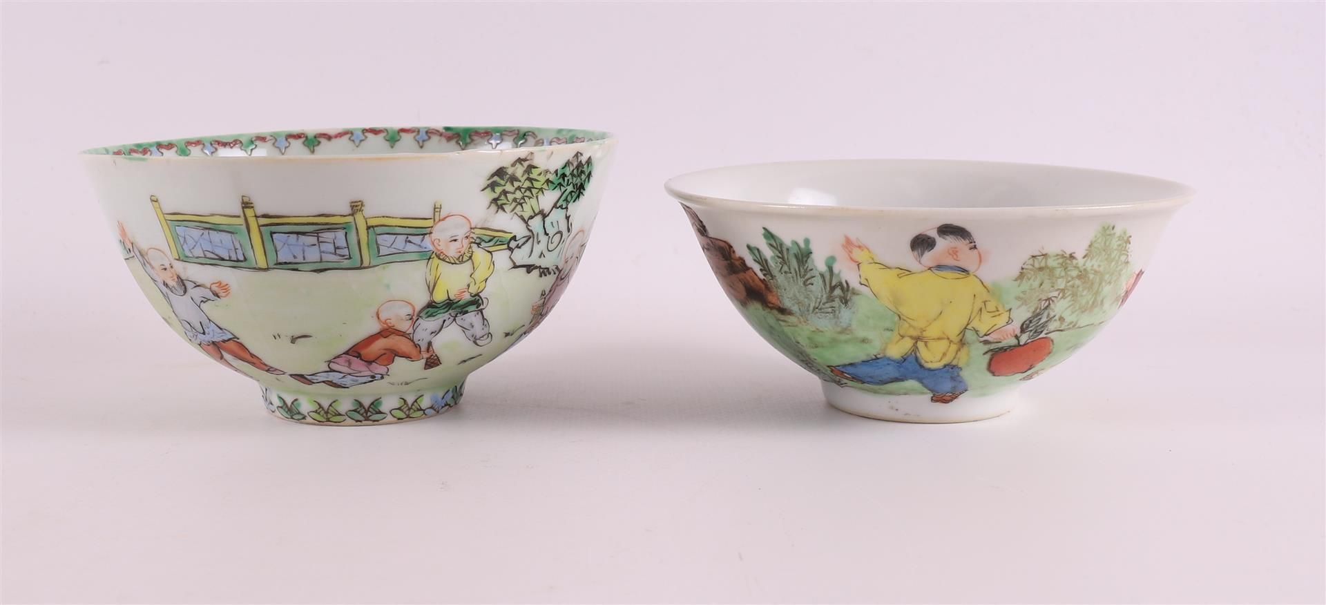 Two porcelain bowls on stand ring, China, 20th century. Polychrome decoration of children playing in