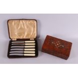 A cassette with fruit knives in original cassette, around 1900. With burr walnut box with inlaid