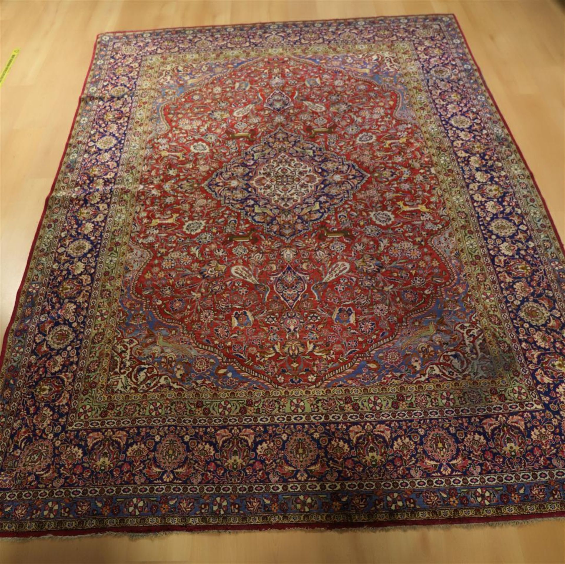 An Oriental silk carpet with red ground and floral motifs, Keshan, Iran, length 295 x w 229 cm (