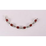 A second grade 835/1000 silver Art Deco bracelet with cabochon cut carnelian, 20th century, l 19