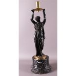 A bronze Greek woman with a candlestick above her head, after an antique example