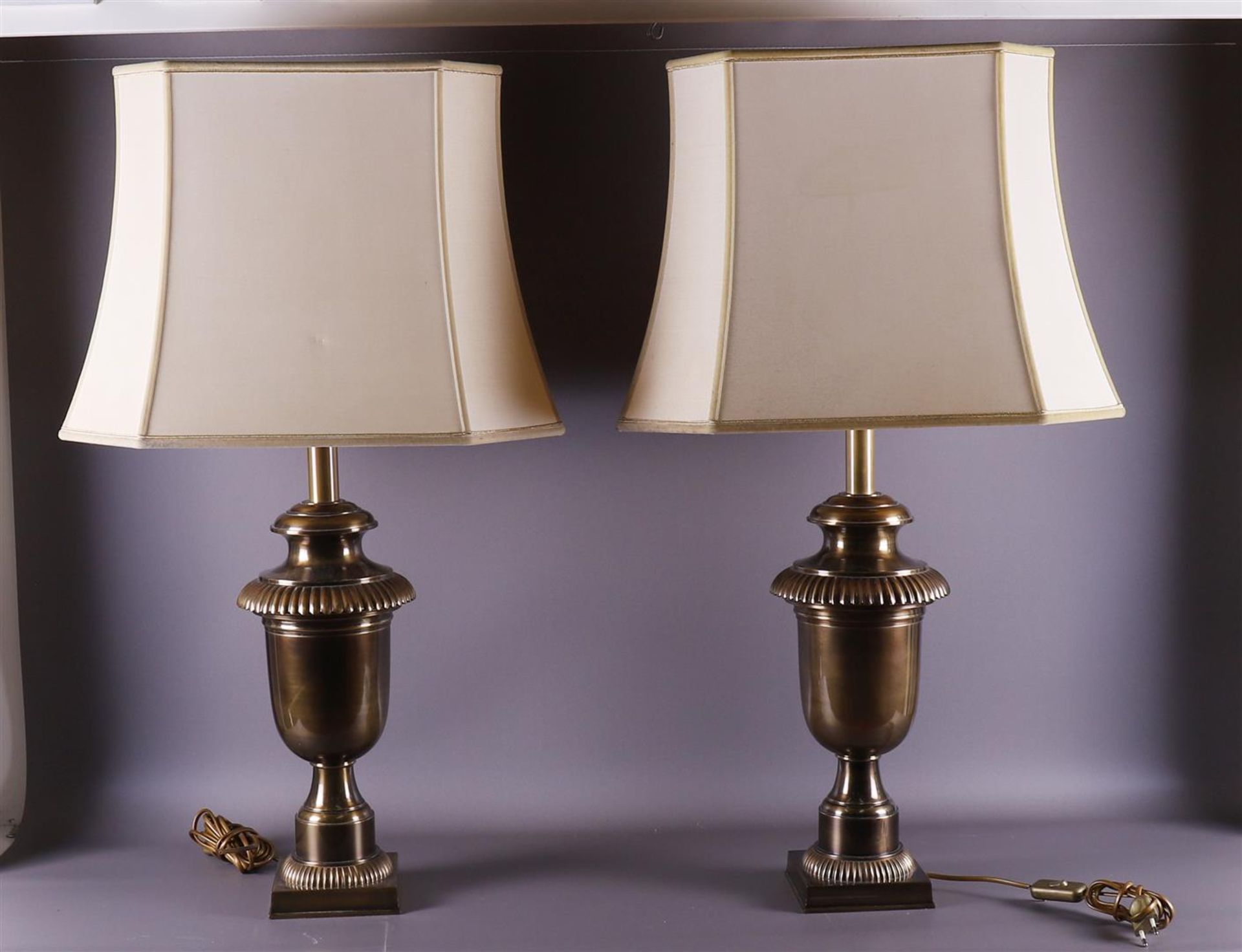 A pair of baluster-shaped bronze lamp bases with fabric lampshades, 20th century