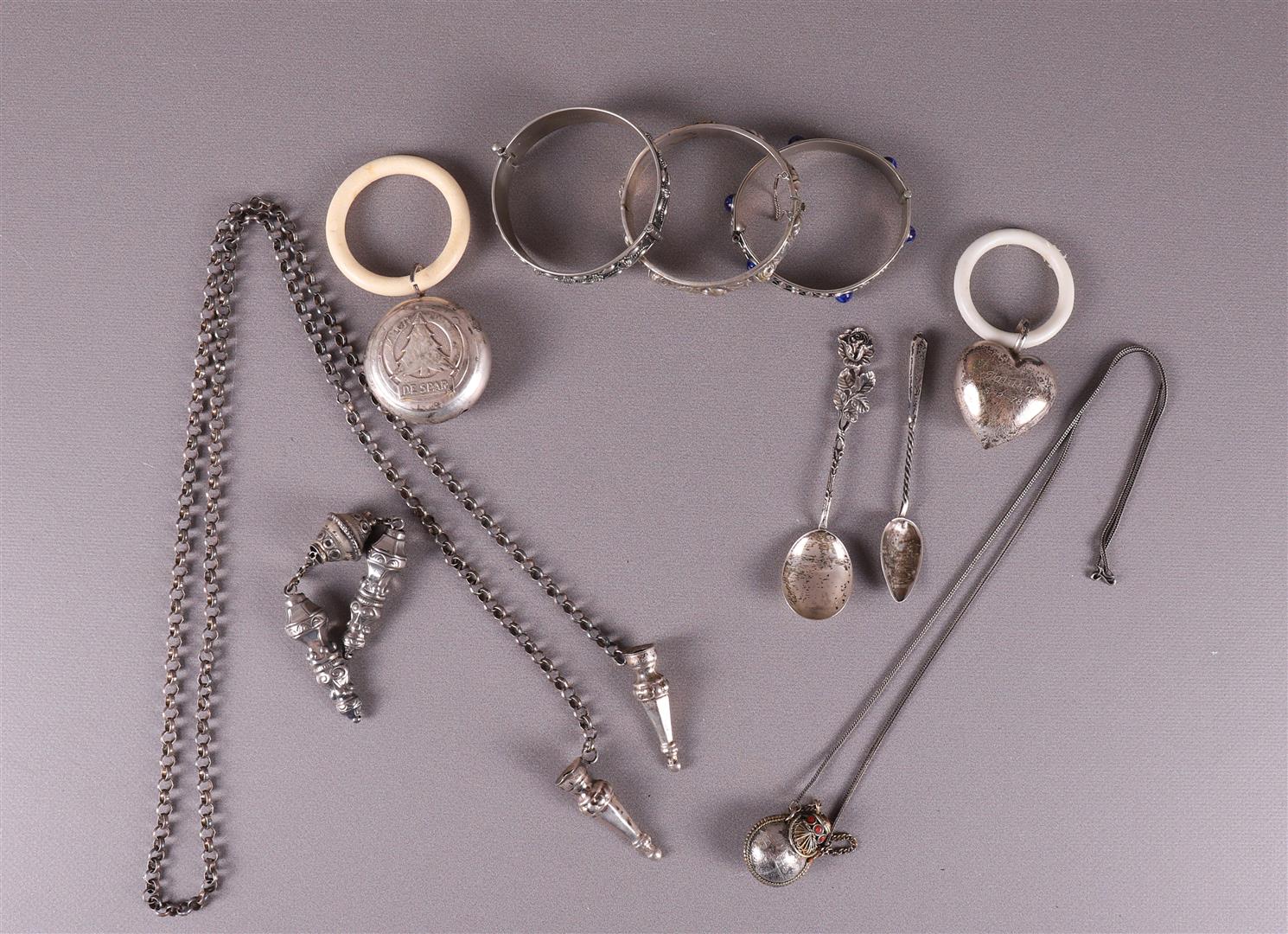 A lot of various jewelery and rattles, including silver, 20th century