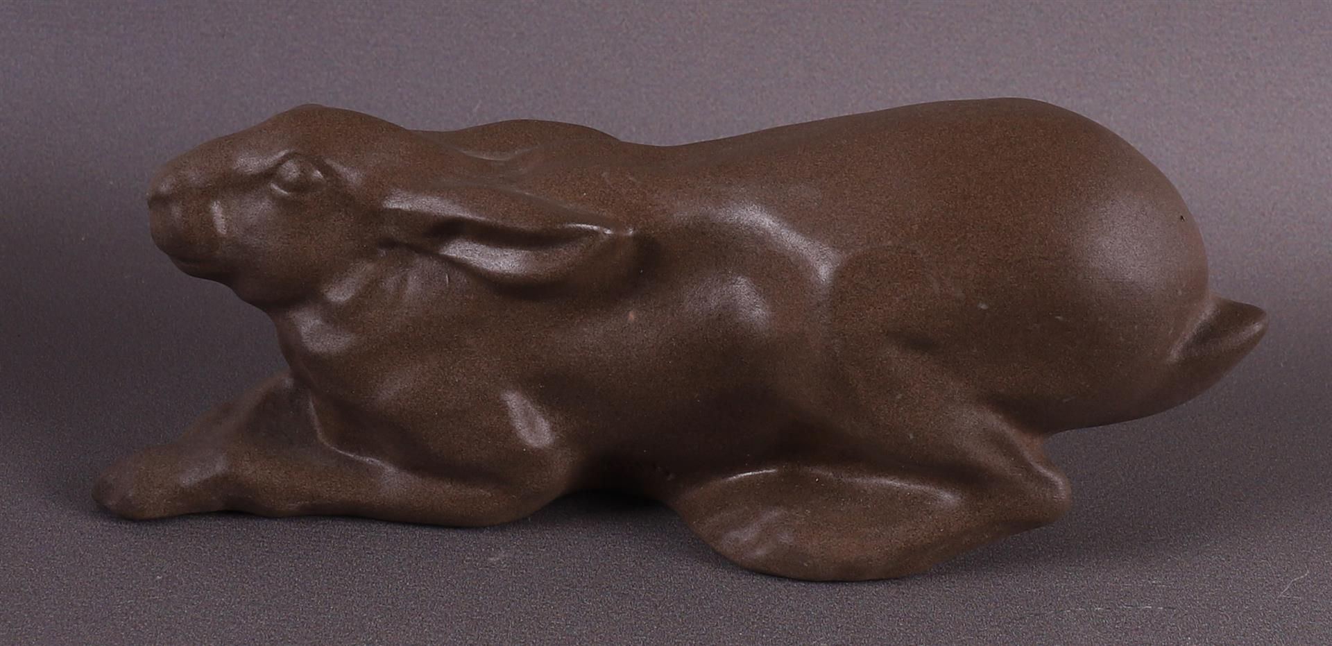 A brown stoneware reclining rabbit, Gien, France. - Image 2 of 4