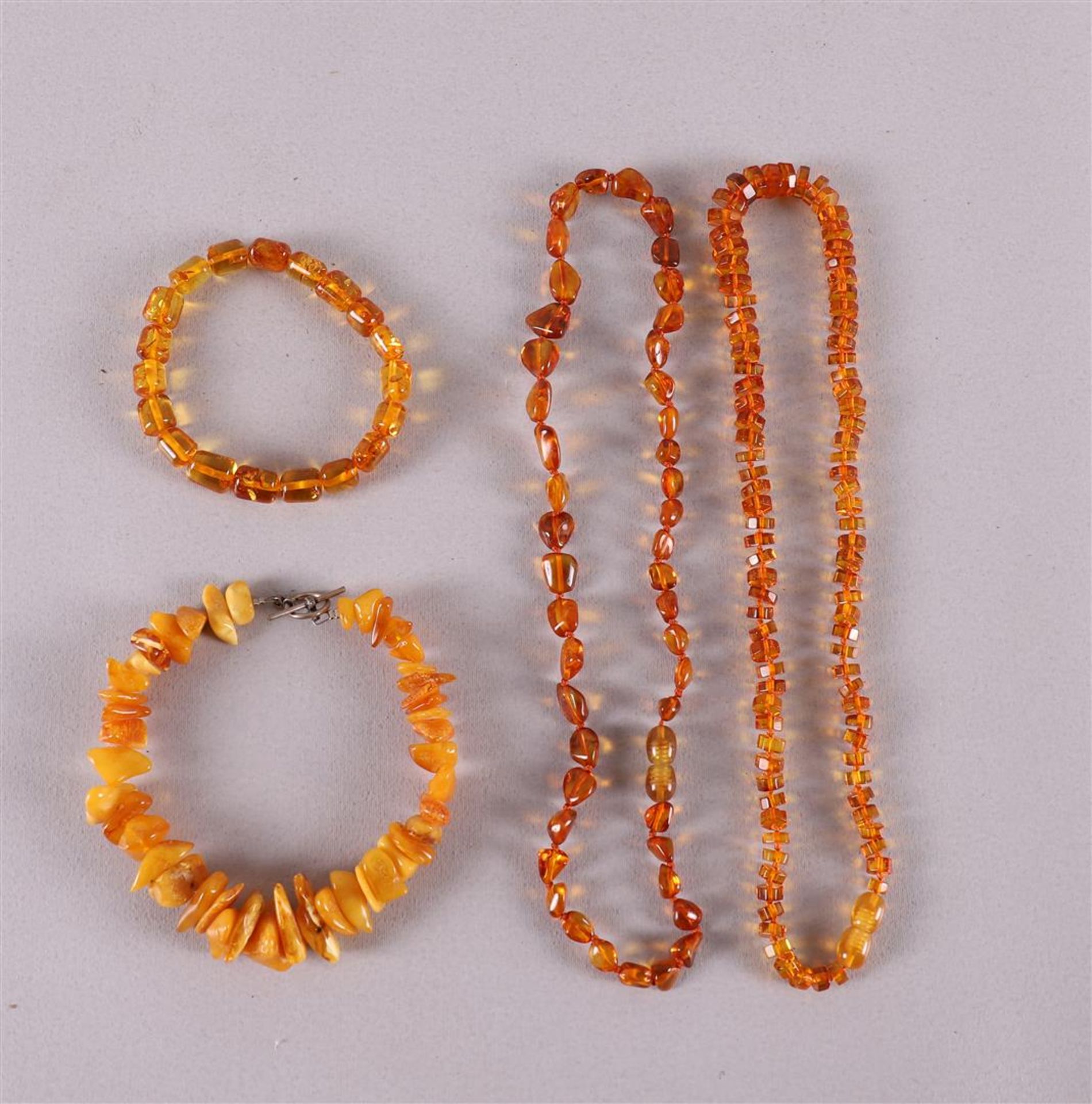 Two different amber necklaces and two ditto bracelets.