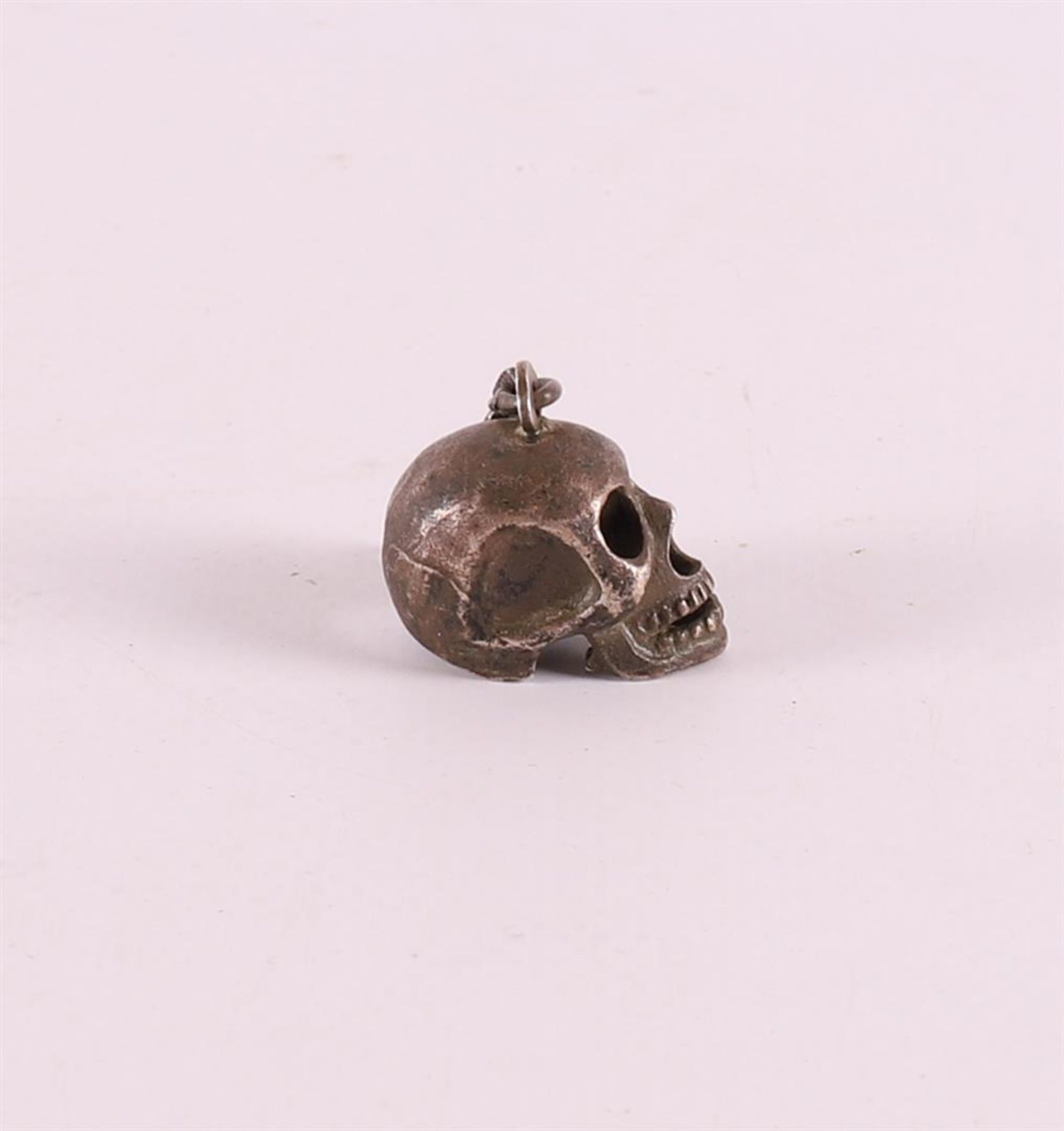 A 3rd grade silver pendant in the shape of a skull, 20th century. - Image 2 of 3