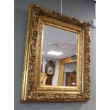 A faceted mirror in a gilded ornamental frame, 1st half 20th century.