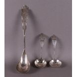 A silver morello spoon and two cream spoons, early 20th century.