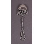 A 3rd grade silver pie scoop with decoration of cherubs.