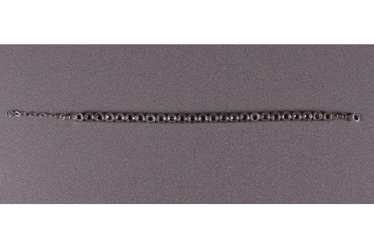 A 1st grade silver tennis bracelet with facet cut blue stones. - Image 3 of 3