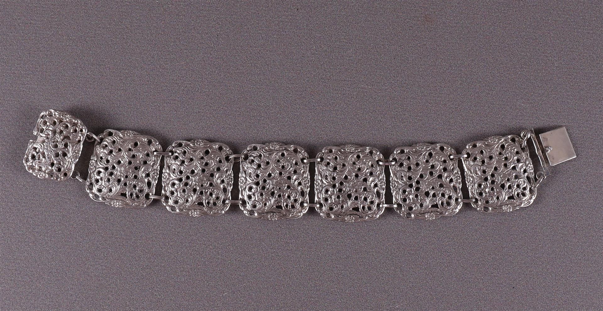 A second grade silver link bracelet with pierced floral decoration