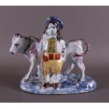 A polychrome Delft earthenware farmer with a cow, 20th century.