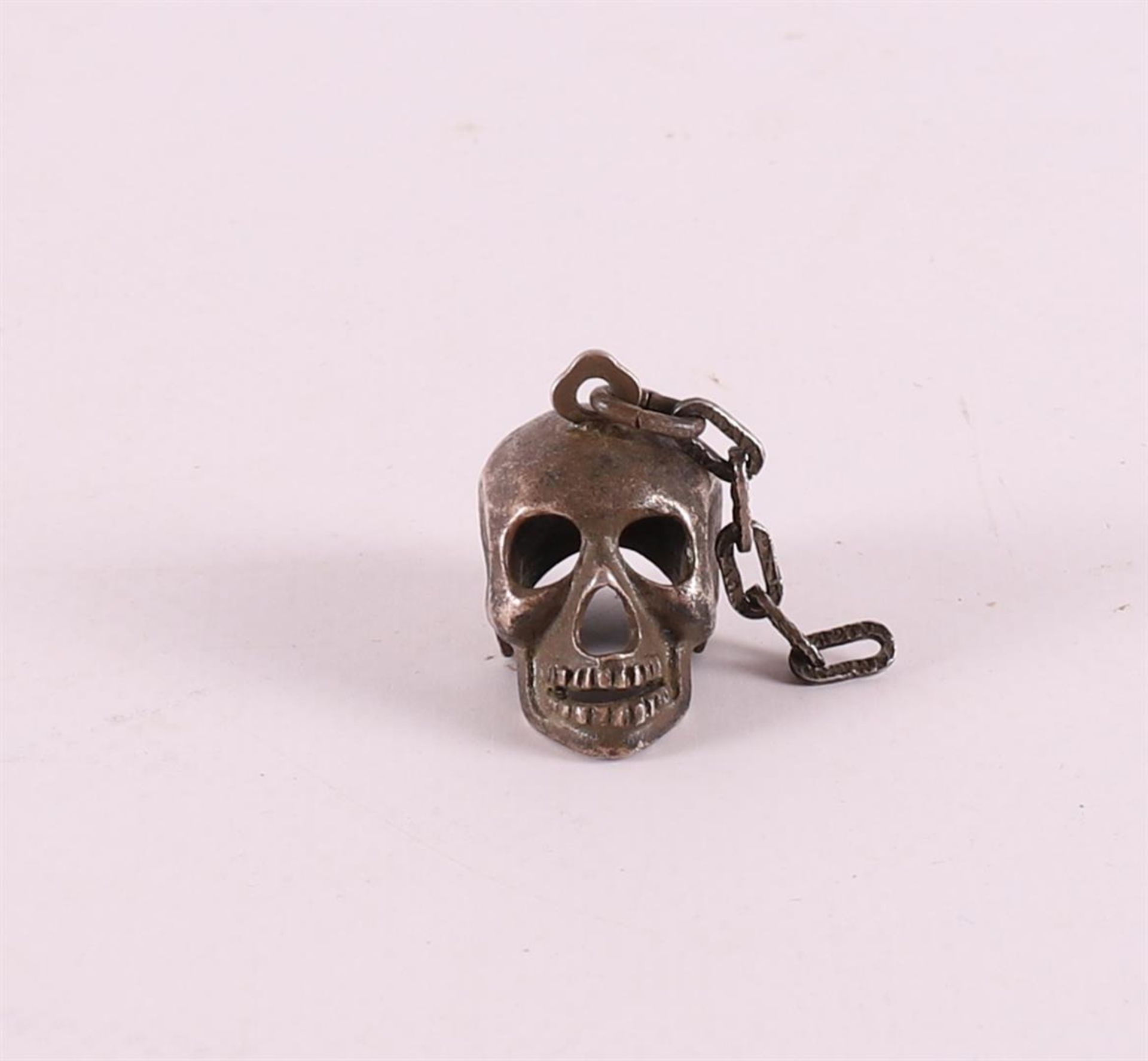 A 3rd grade silver pendant in the shape of a skull, 20th century.