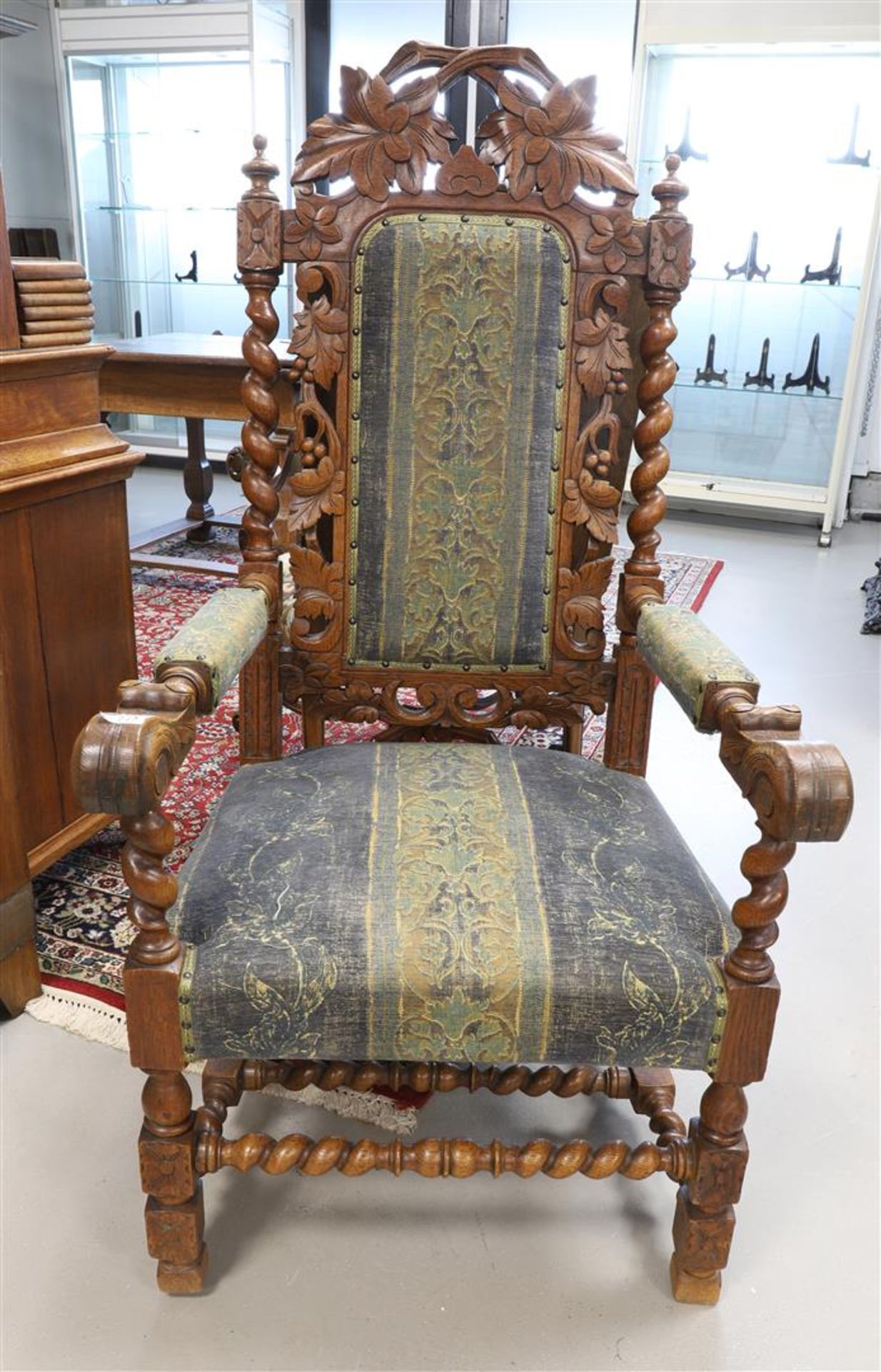An oak armrest armchair with green fabric upholstery, 19th century