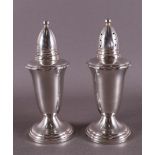 A pair of silver baluster shaped salt and pepper shakers, England, 20th century