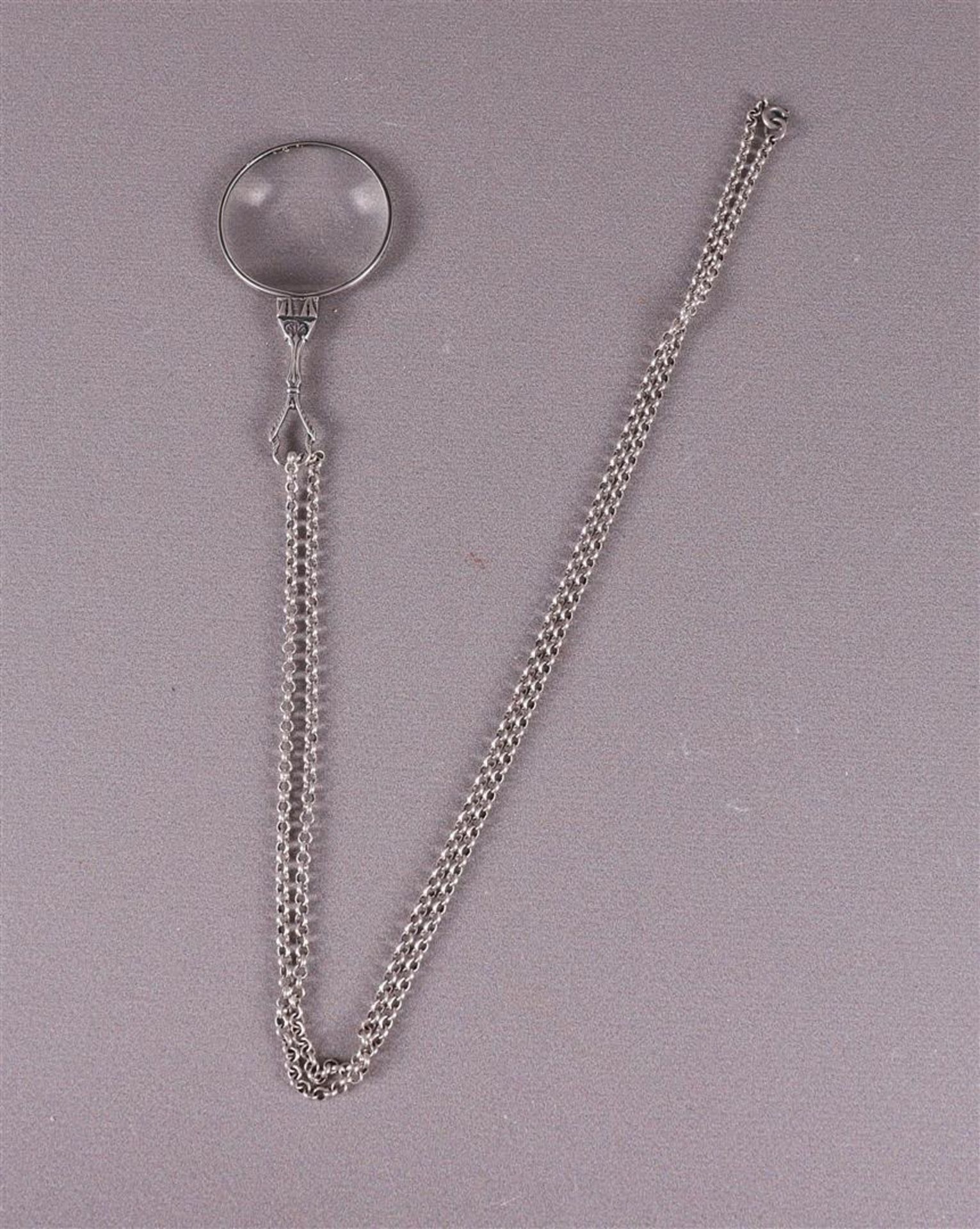A silver loupe on a ditto silver jasseron necklace, 20th century.