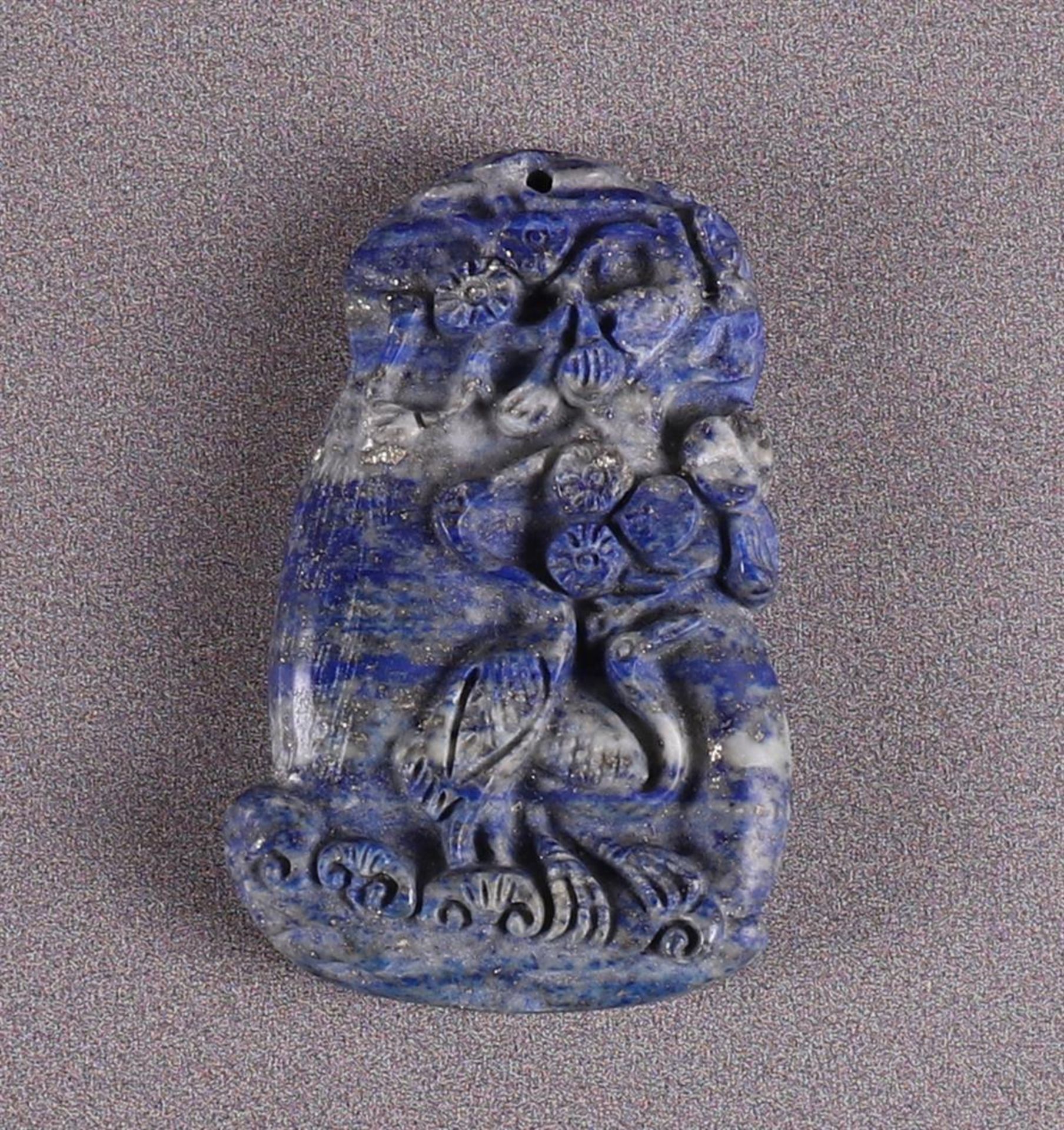 A lapis lazuli pendant with a relief depiction of a crane near prunus, China