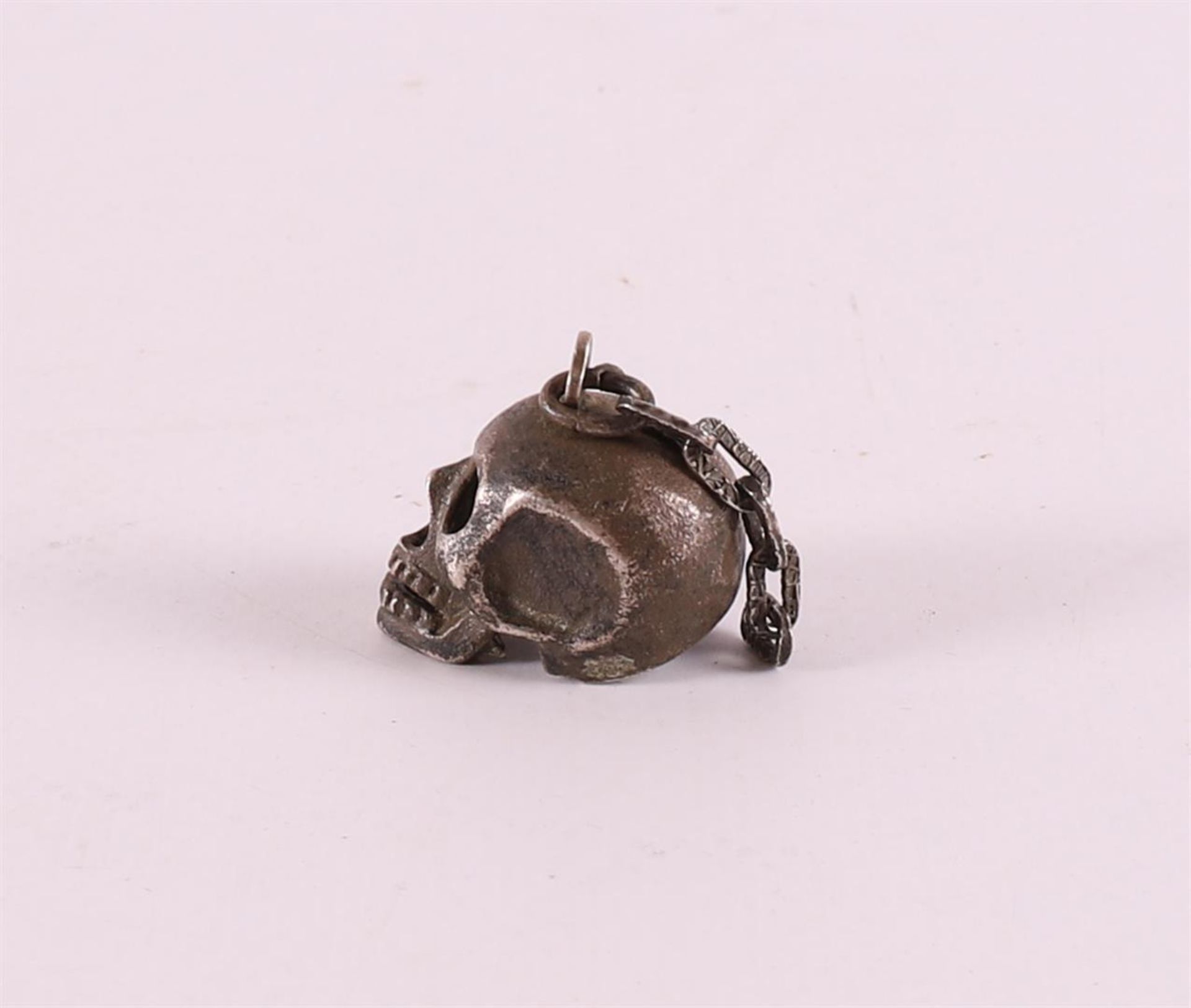 A 3rd grade silver pendant in the shape of a skull, 20th century. - Image 3 of 3