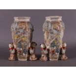 A pair of Satsuma earthenware decorative vases flanked by fools, Japan, Meiji,