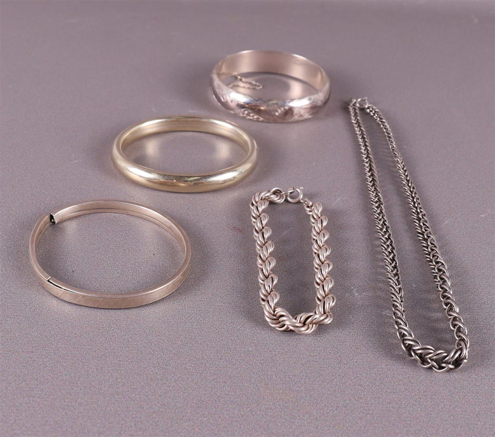 Four various silver bracelets, including slave bracelet + necklace.