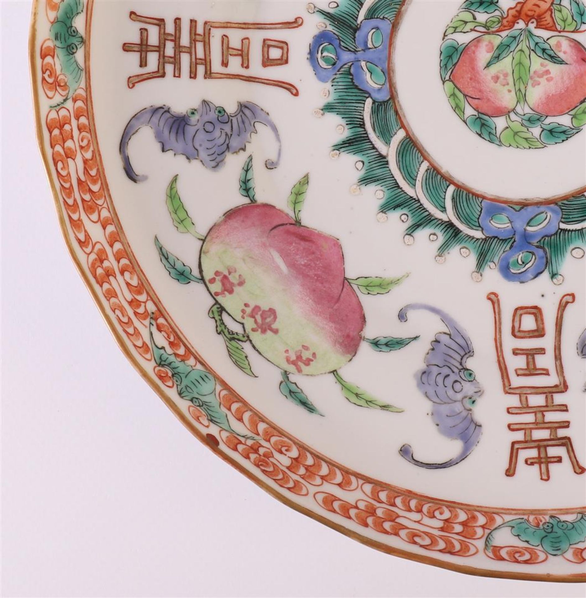 A slightly contoured porcelain dish, Japan, 19th century. Polychrome decor of peaches, bats and - Image 5 of 12