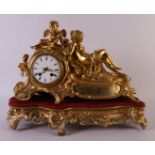A gold-plated mantel clock on loose wooden base, France, mid-19th century. Clock case with decor