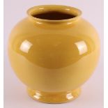 ADCO, Groningen. A yellow glazed earthenware spherical vase, early 20th century. Marked: Adco, model