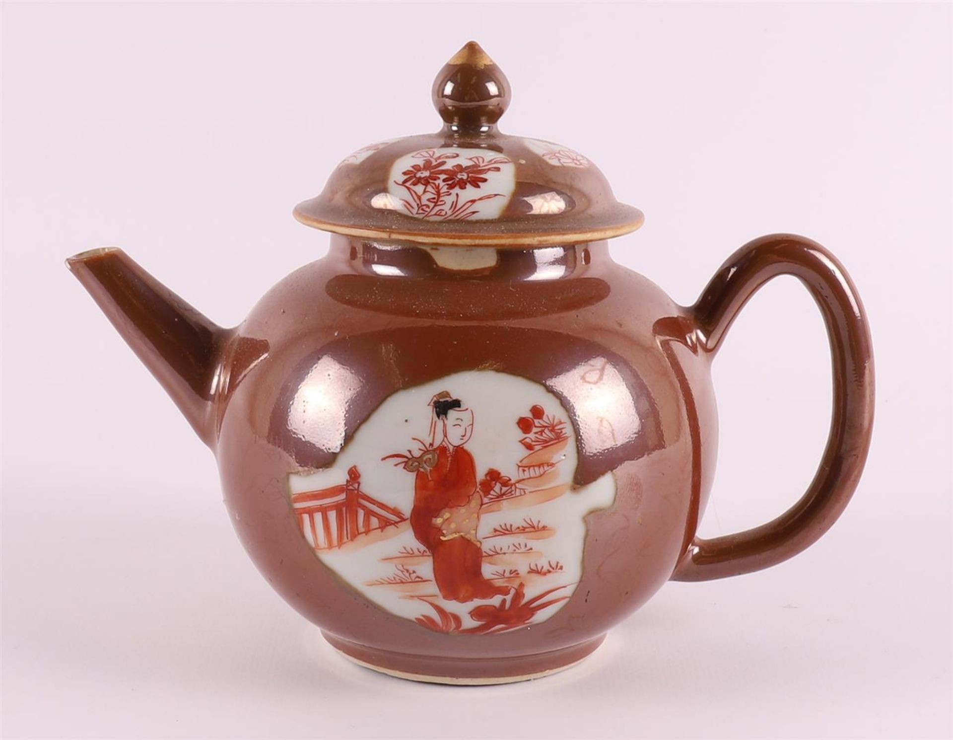 A porcelain teapot with 'rouge de fer' decor of long ledge in a garden on capucine ground, China,