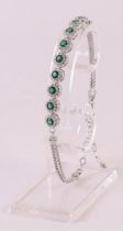 A 1st grade 925/1000 silver bracelet with facet cut green stones and zirconias.