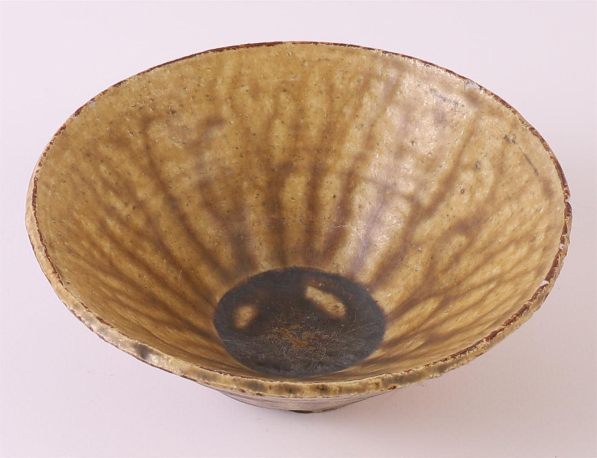 A brown glazed earthenware conical Temmoku bowl, China, Song dynasty 12th century, h 5 x Ø 13.5