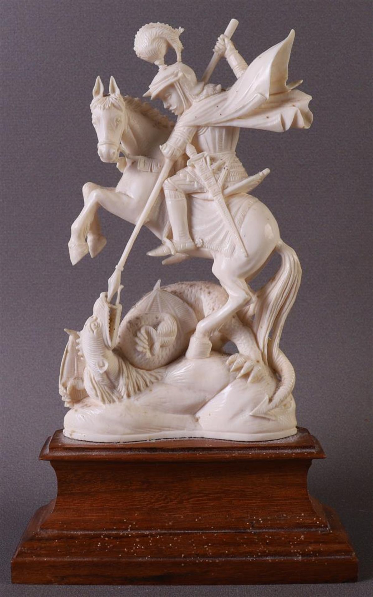 A carved ivory sculpture of Saint St. George and the dragon, depicted on a prancing horse, France,