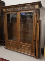 A bookcase in neo-Renaissance style, Holland, around 1900. Straight profiled hood with carved
