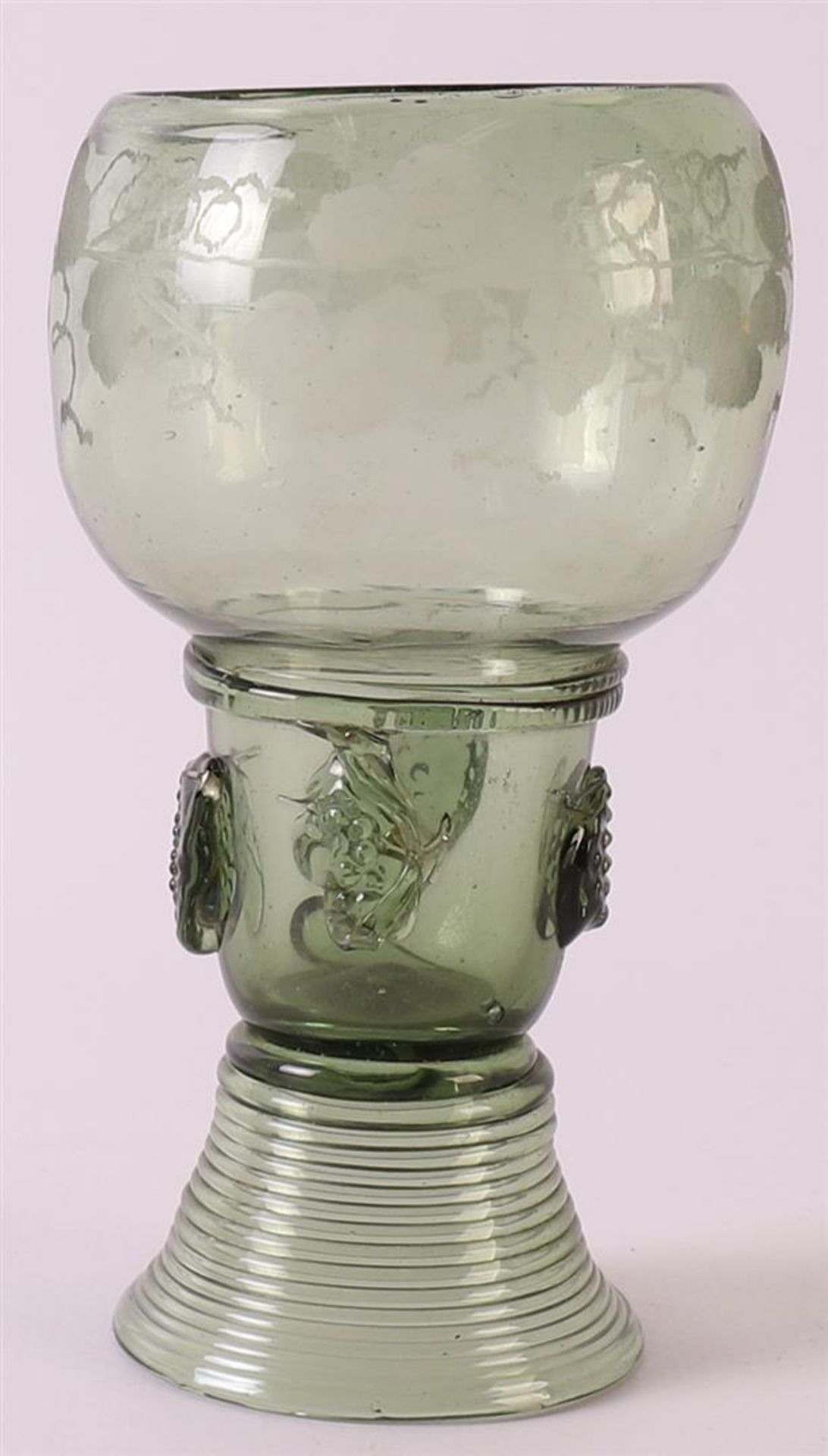 A green glass stemmer, Germany 18th century. Chalice-shaped cuppa, stem with burrs, resting on round