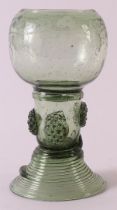 A green glass stemmer, Germany 18th century. Chalice-shaped cuppa, stem with burrs, resting on round