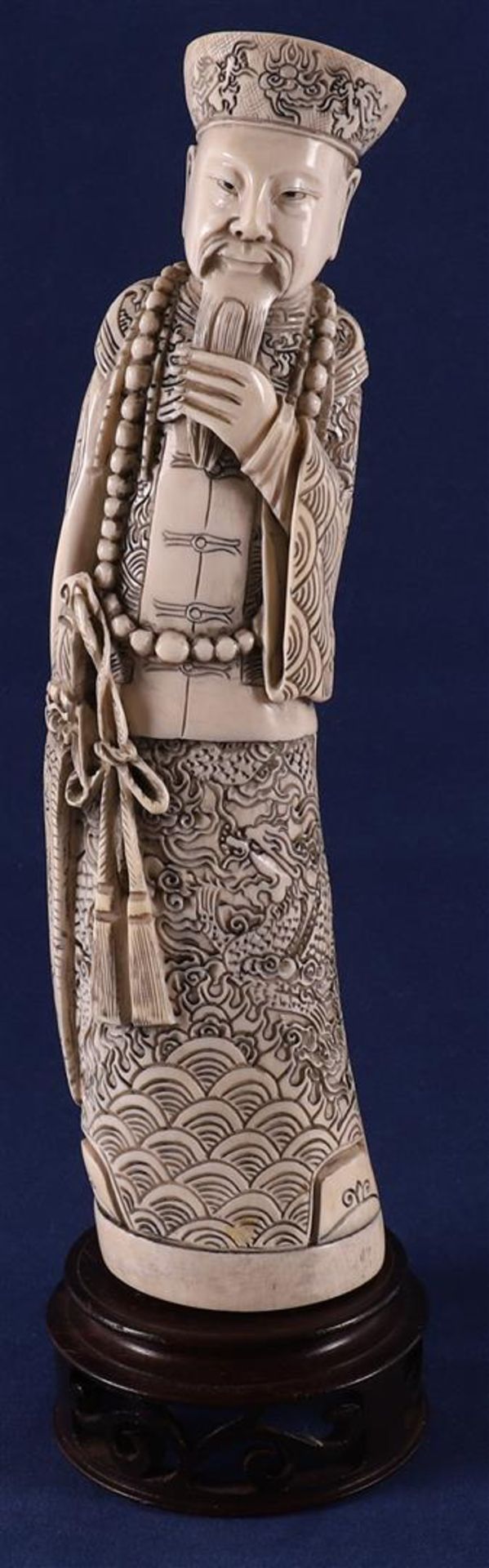 A carved ivory figure of a Mandarin, China, late 19th century. Signed 'Qianlong' bottom, h30 cm,