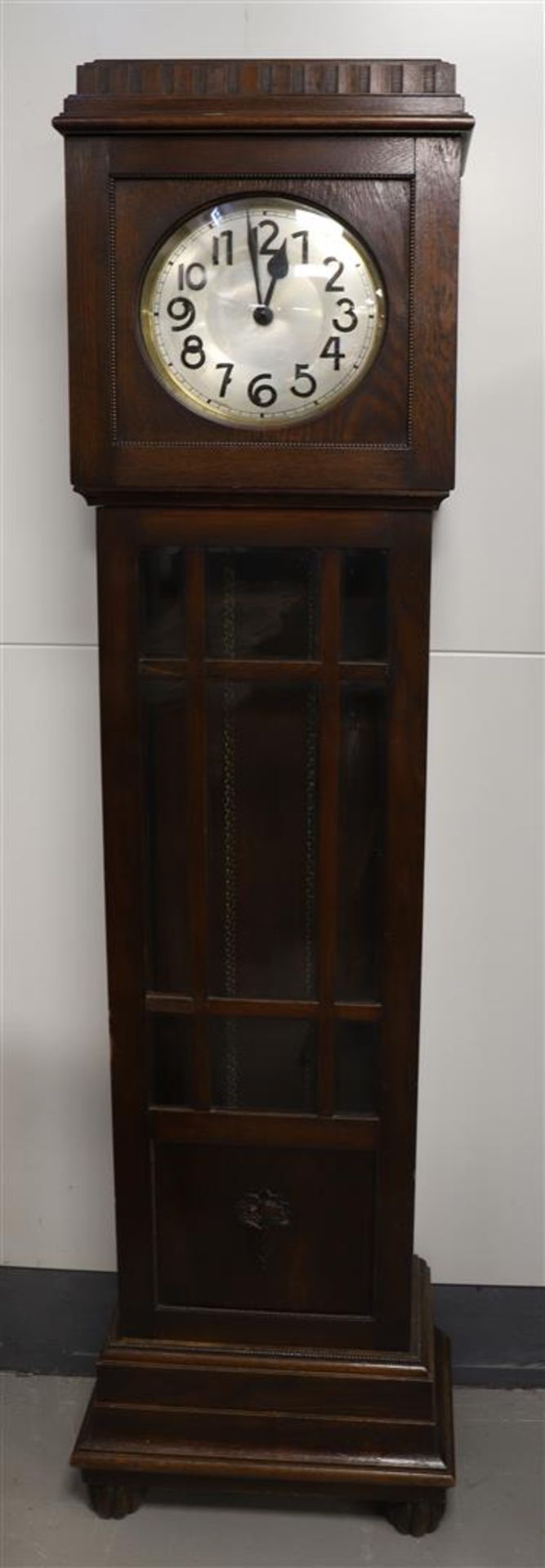 A grandfather clock, Germany, ca. 1930. Oak casing, copper dial with Arabic numerals, weights and