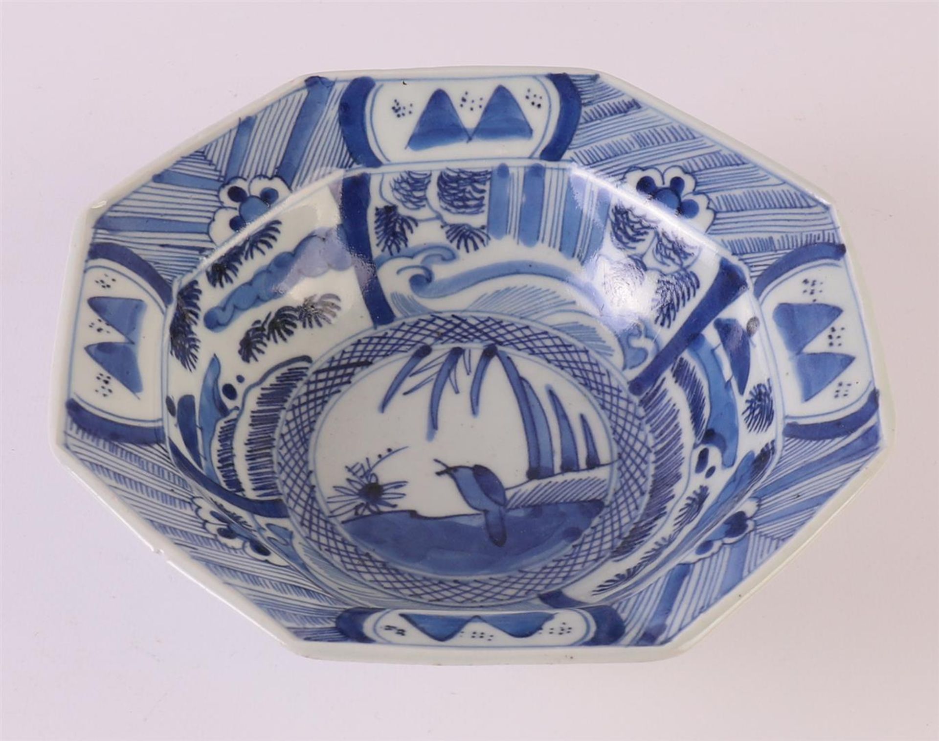 An octagonal blue/white porcelain hooded bowl, China, around 1800. Blue underglaze decor of a crow
