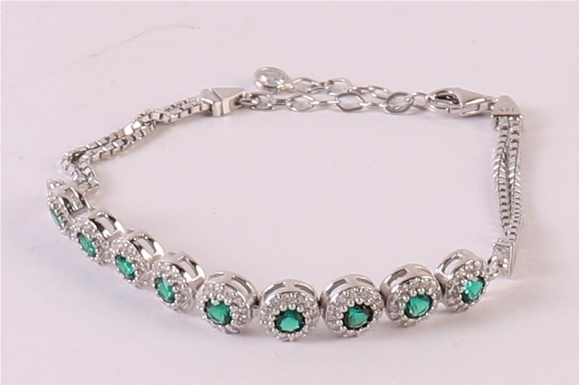 A 1st grade 925/1000 silver bracelet with facet cut green stones and zirconias. - Image 2 of 3