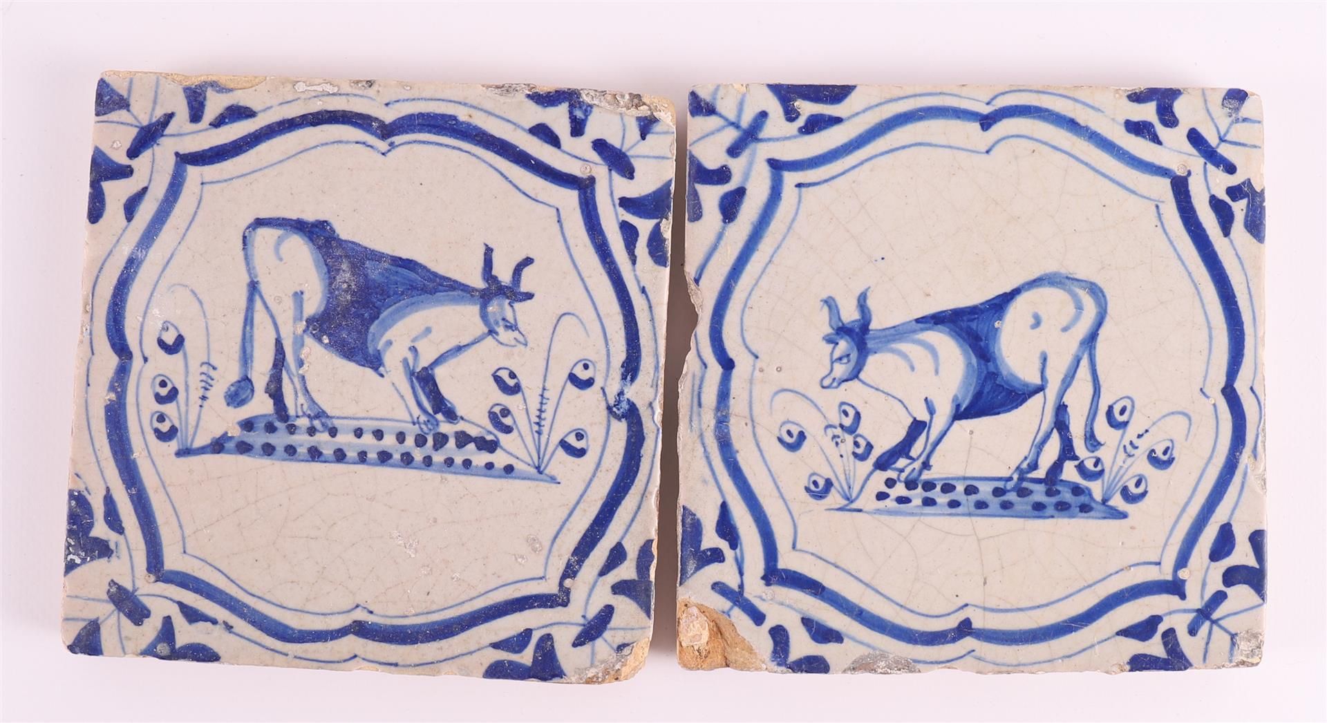 Two blue/white tiles with a cow incartouche decor with 'winged-leaf' corners, Holland, 17th century,