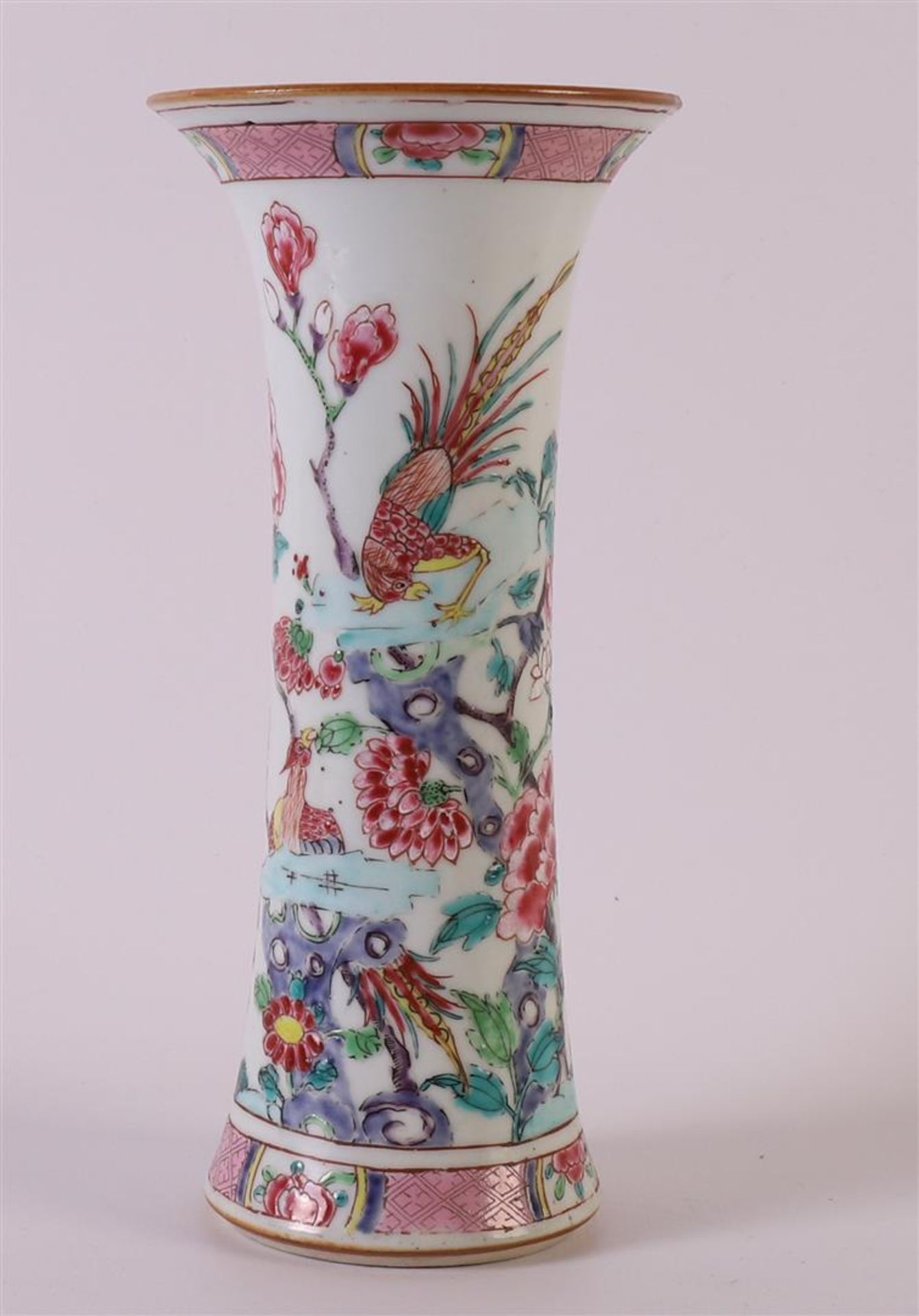 A trumpet-shaped porcelain famille rose vase, China, 18th century. Polychrome decor of birds and