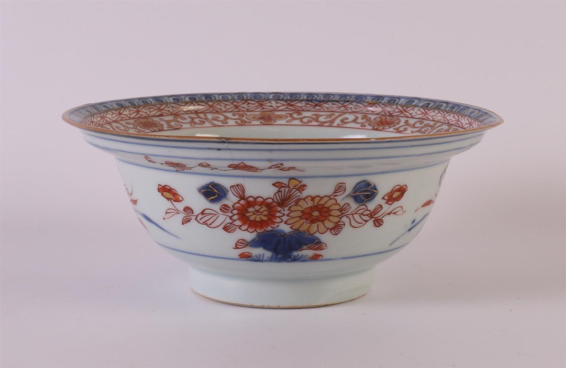 A porcelain hooded bowl, China, Qianlong 18th century. Blue/red, partly gold heightened floral