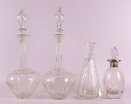 A pair of cut crystal baluster-shaped decanters with long necks, circa 1900. Faceted decoration.