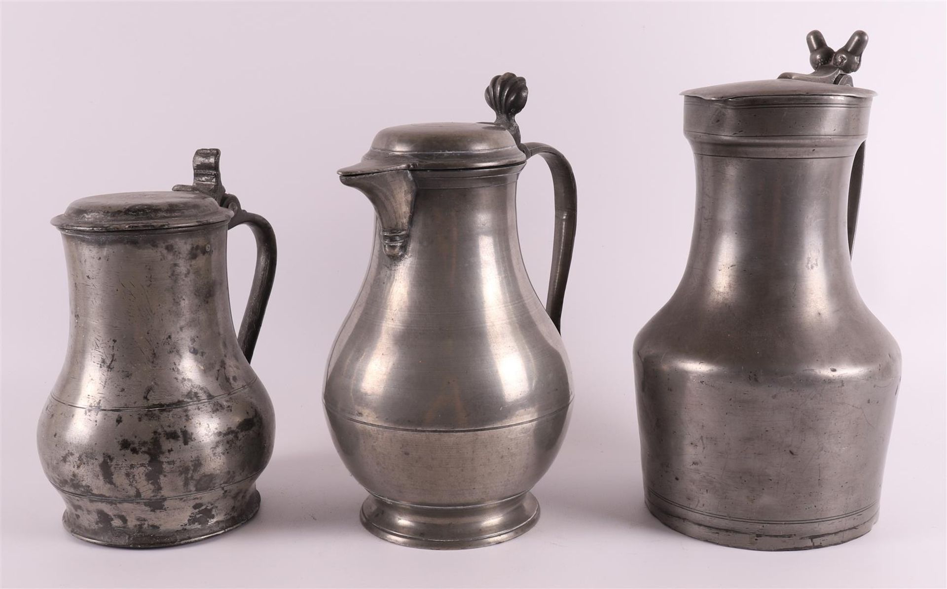 A clear pewter wine jug, so-called acorn jug, France 18th century, h 25.5 cm. Here are two other