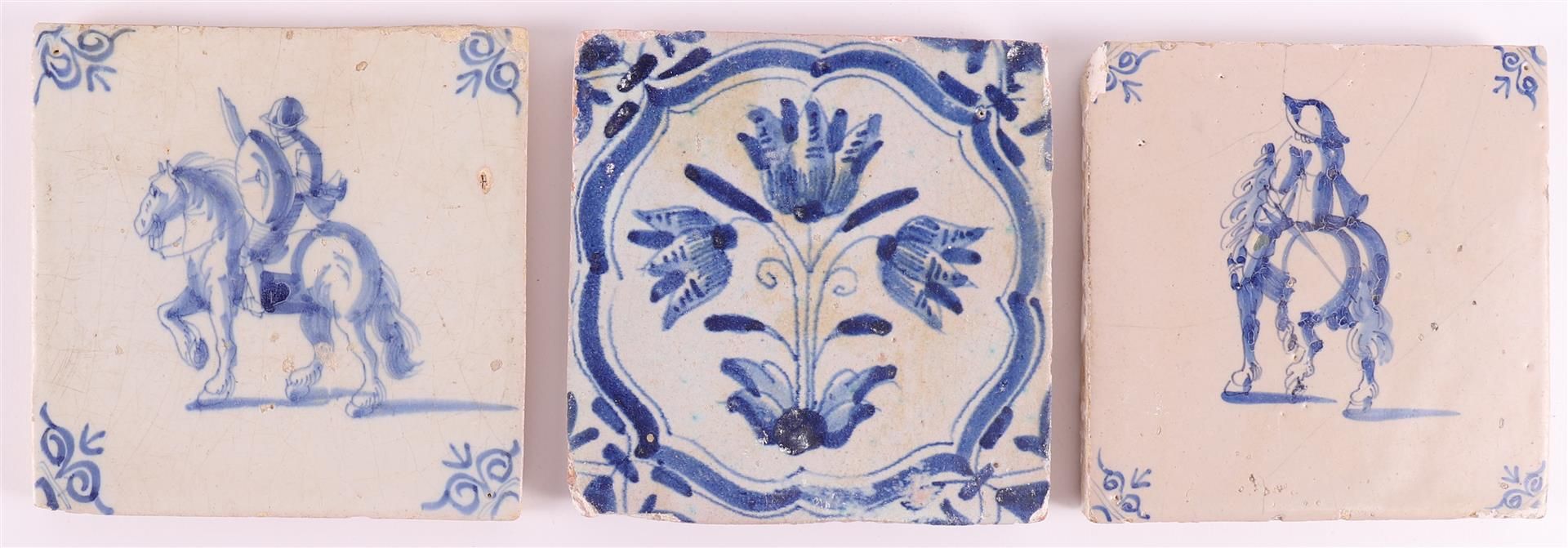 Two blue/white equestrian tiles with ox head corner motifs, Holland 17th century. Here is a flower