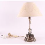A silver plated brass table lamp with conical fabric shade, 20th century. Applications of winged sea