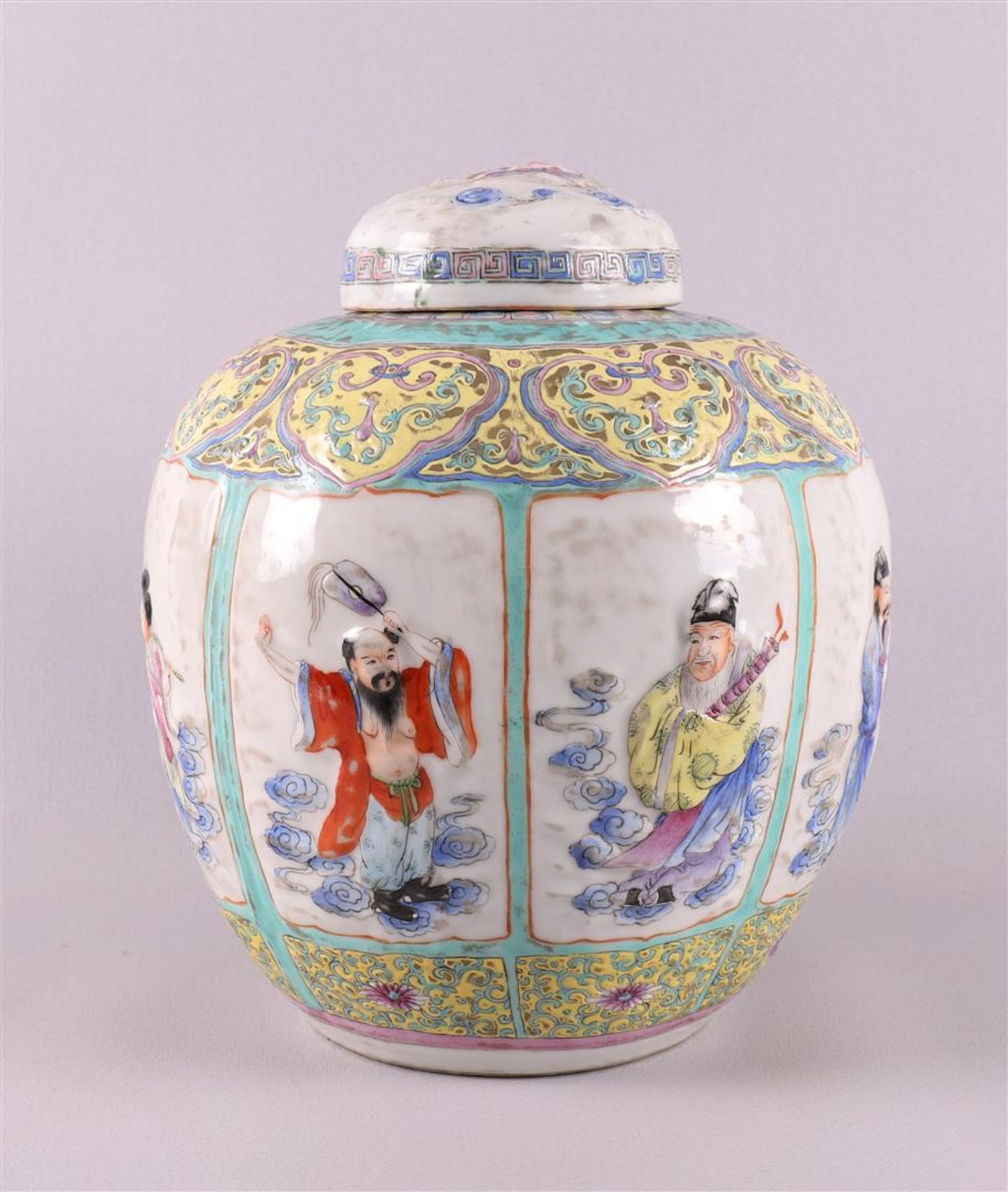 A porcelain ginger jar, China, around 1900. Polychrome relief decoration of figures in cartouches