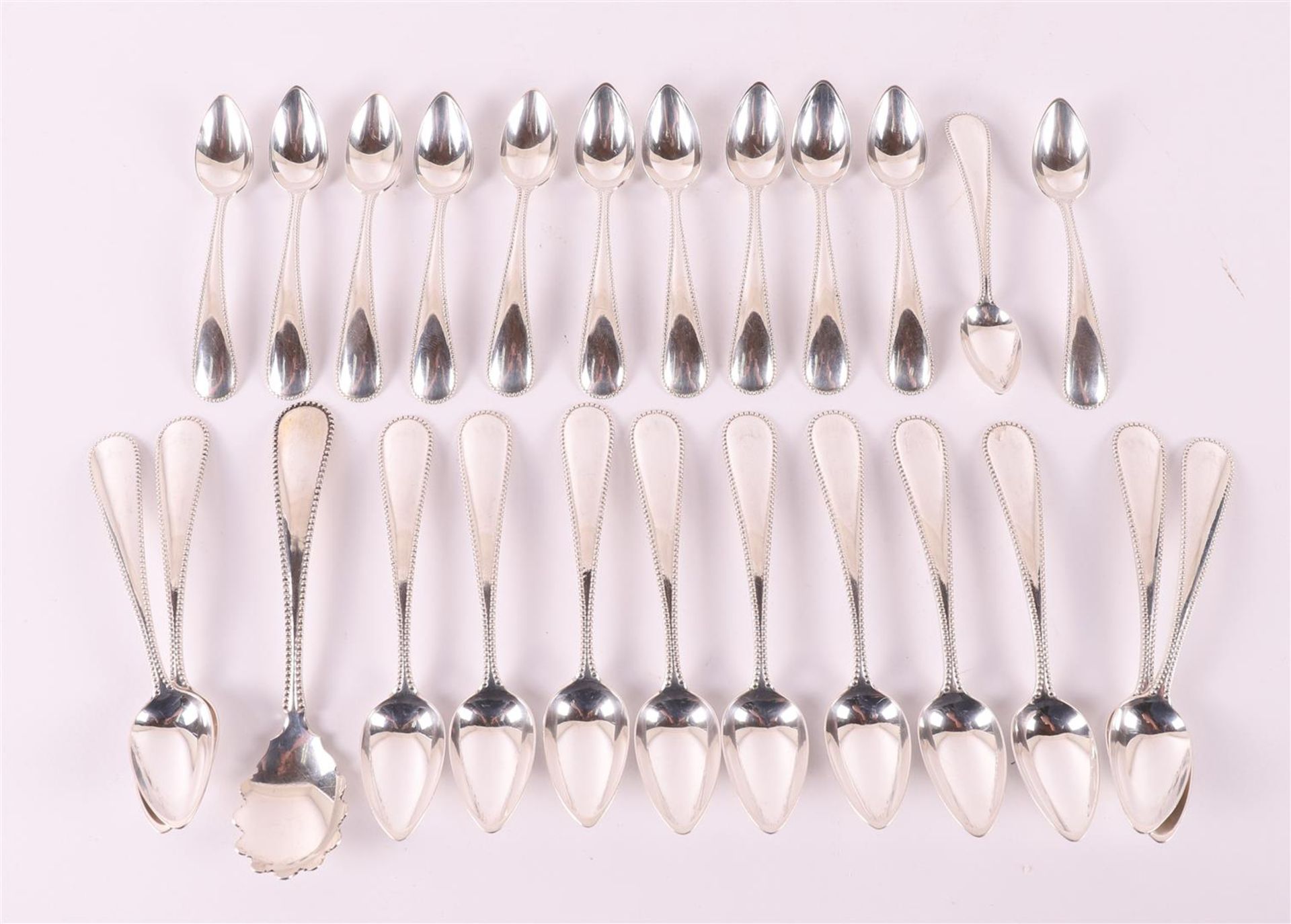 A set of twelve second grade 835/1000 silver teaspoons, mocha spoons and a sugar spoon with a