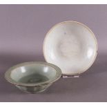 A green glazed celadon bowl with relief decoration of two fish, China, Song/Ming, h 3.8 x Ø 13 cm.