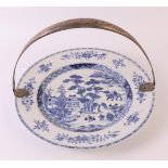 A blue/white porcelain dish with second grade 835/1000 silver handle of a later date, China,